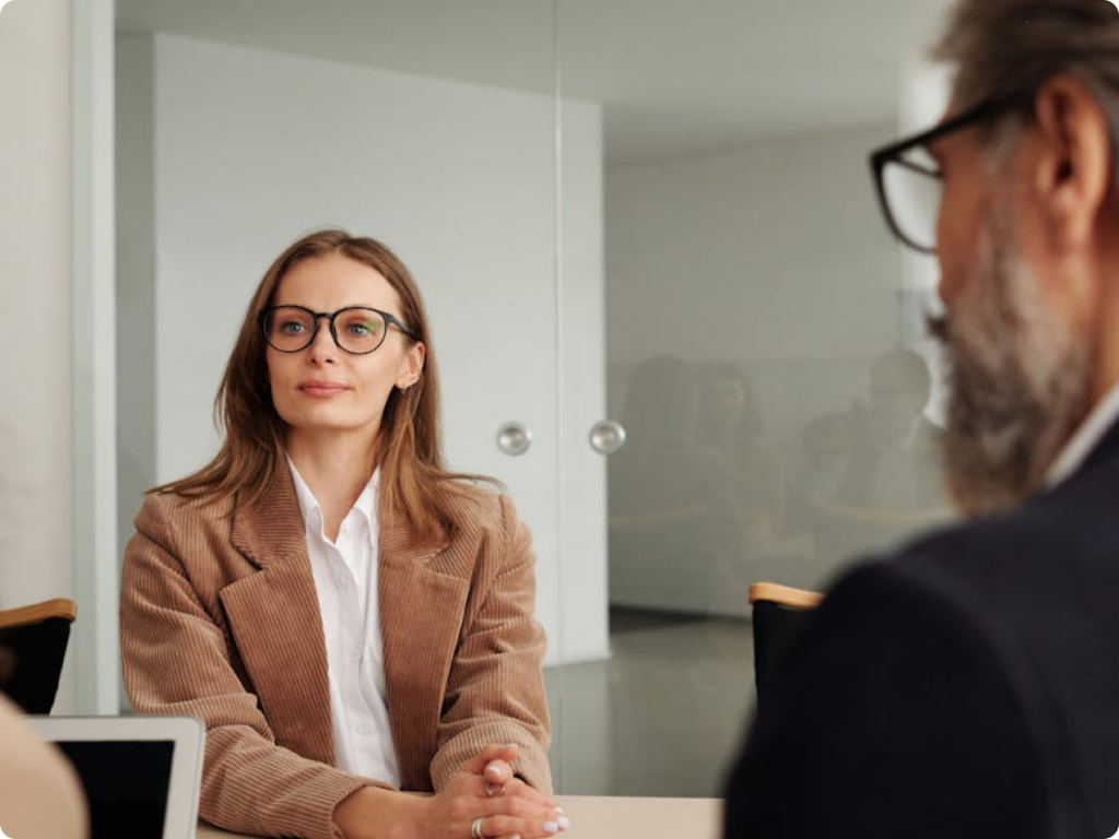 Young woman sitting across from loan agents during a financial consultation